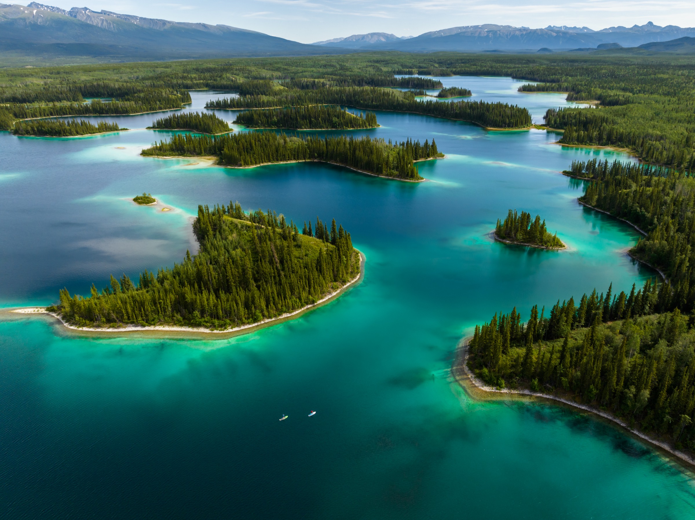 Aerial view of turquoise lakes and forested islands in northern British Columbia